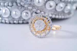 Close-up of an elegant diamond ring with intricate design on a reflective surface.